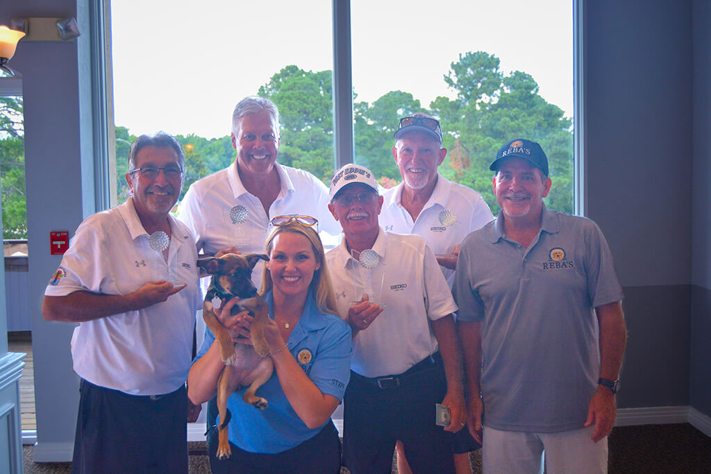 The winning team with Charlie, Meagan and one of the puppies that was available for adoption.