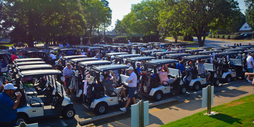 The golf cart line up at our golf tournament was packed full. Golfers were getting all their gear in the carts to start the tournament.