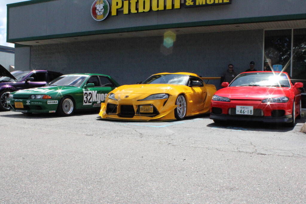 green yellow and red car in front of pitbull tobacco store