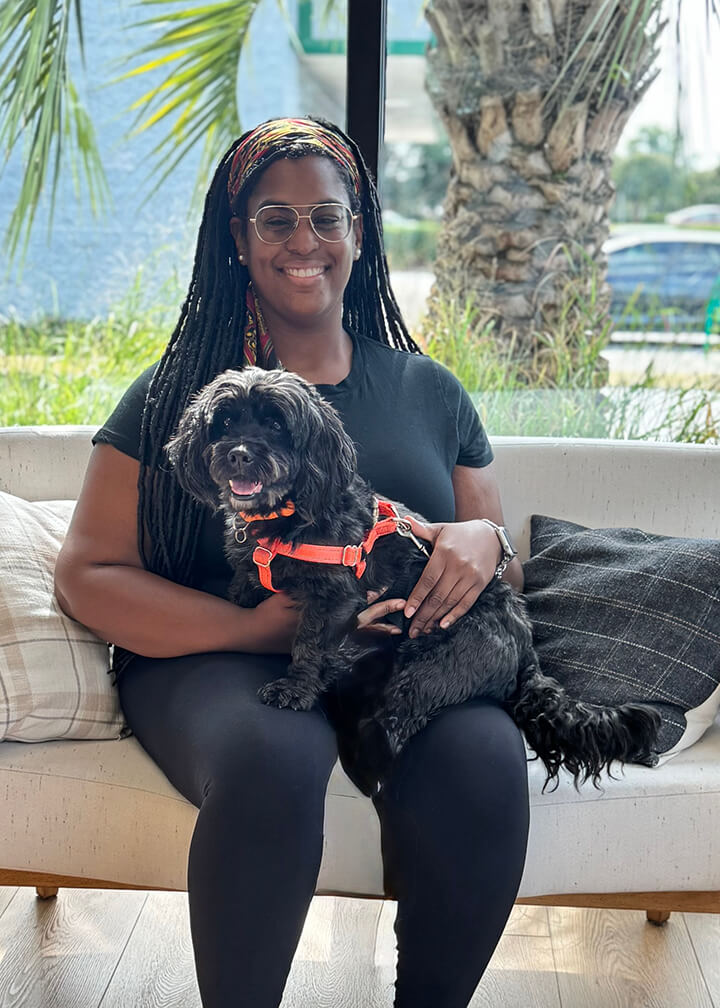 September 2025 adoption of Pepper a black curly dog