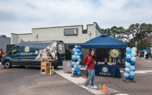 Reba's Animal Rescue and Adoption Center store back and entrance to event. Balloons and the van decorated the area for donation collection.