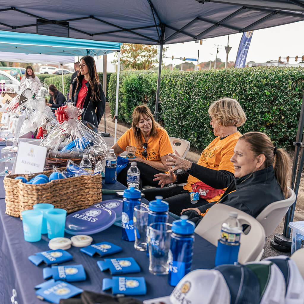Reba's volunteers working the merch booth