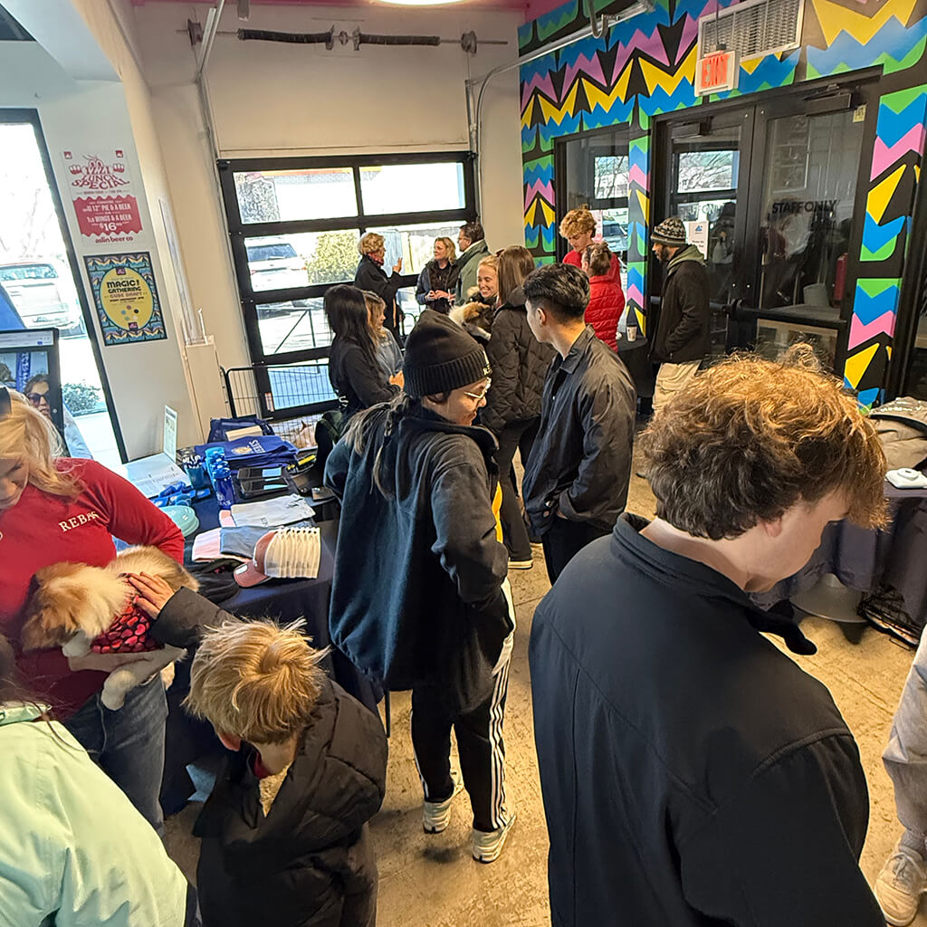 Many guests gather and pet the animals at the Puppy Bowl