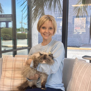 Staff photo of Michelle with adoptable cat.