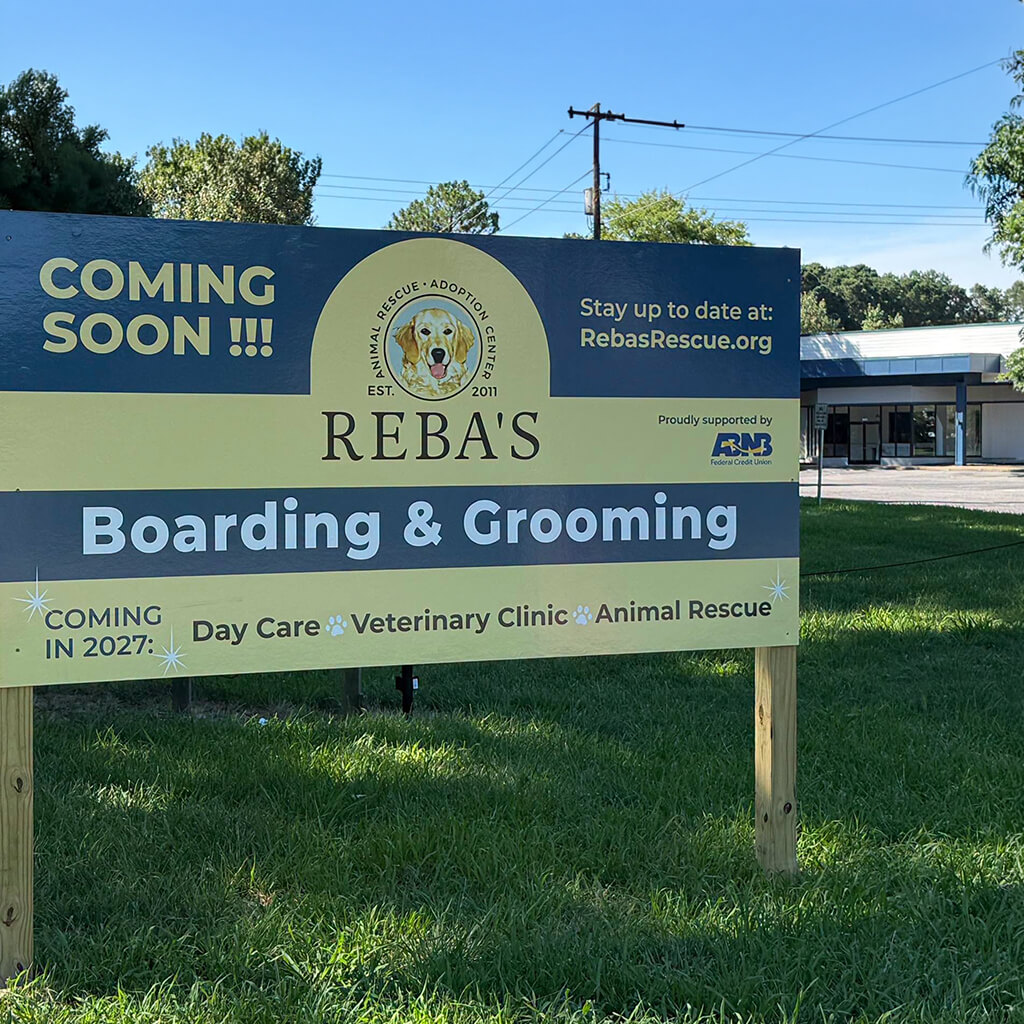 Progress picture: Coming soon sign with the painted building in the background.