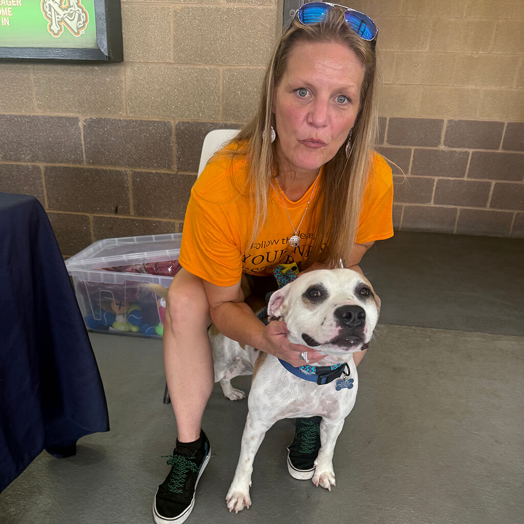 One of our volunteers pose with an adoptable dog