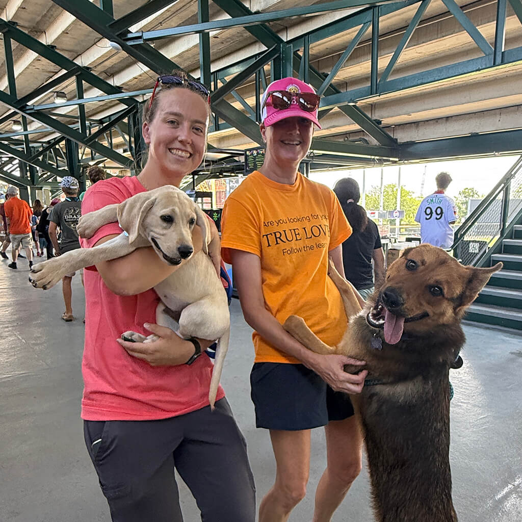 Two of our helpers pose with two dogs