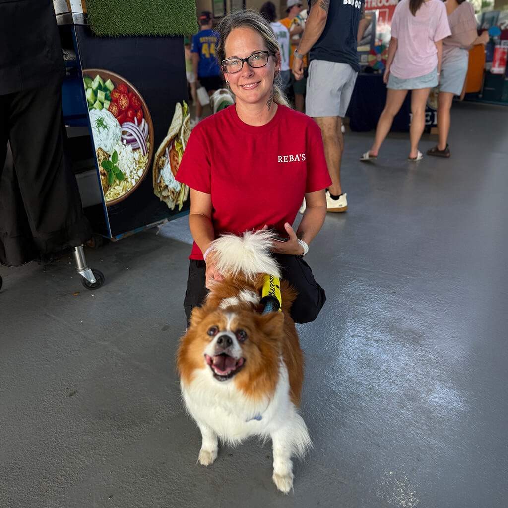 Happy dog being held by our volunteers